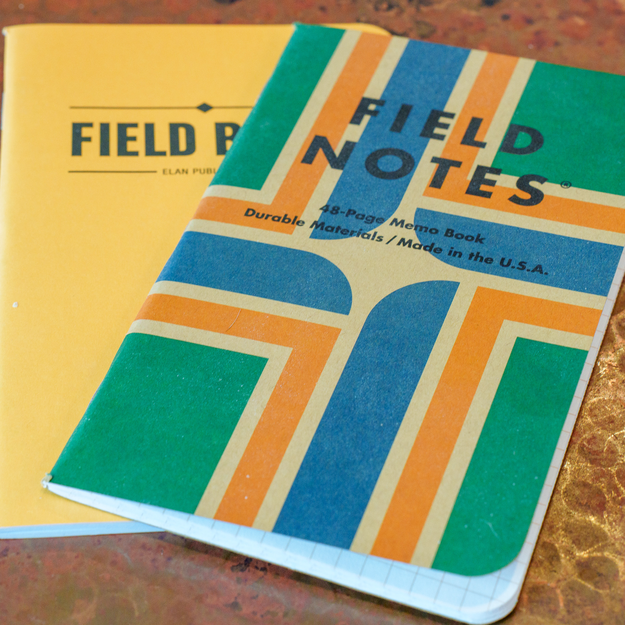 2 Field Notes notebooks on a copper table